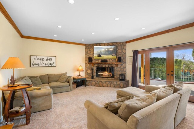 living area featuring light colored carpet, crown molding, and a stone fireplace