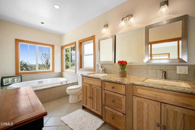 bathroom with double vanity, decorative backsplash, a sink, and tile patterned floors