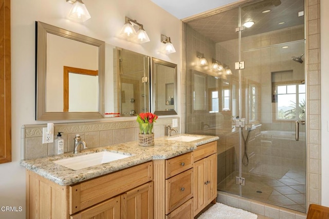 bathroom with a sink, a shower stall, decorative backsplash, and double vanity