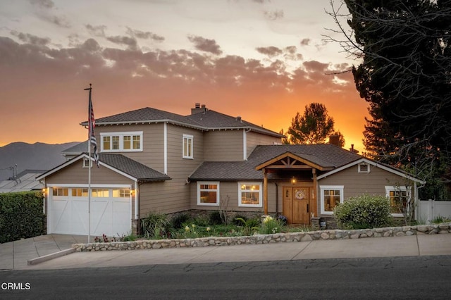 view of front of property featuring driveway, a chimney, and fence