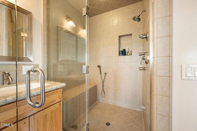 bathroom with a stall shower, backsplash, and vanity