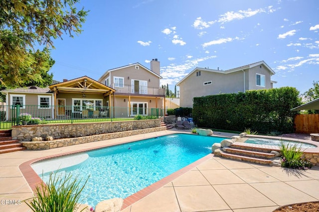 view of swimming pool with an in ground hot tub, a patio area, fence, and a fenced in pool