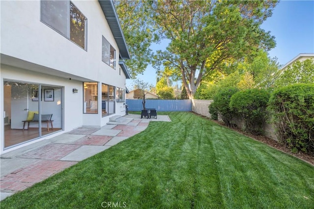 view of yard with a fenced backyard and a patio area