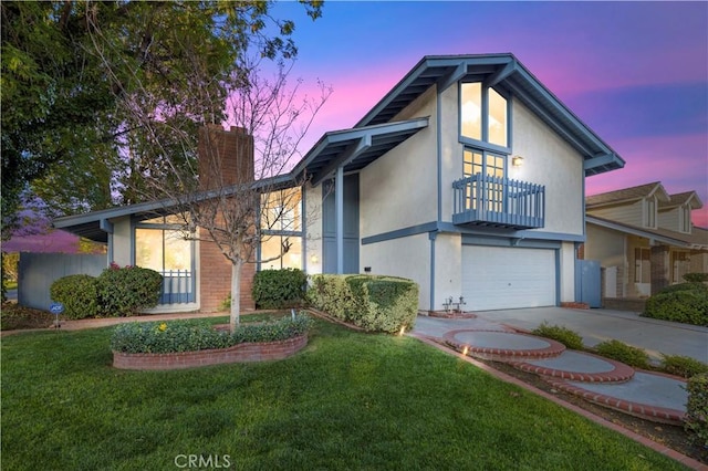 view of front of house featuring driveway, a front yard, a garage, a balcony, and a chimney