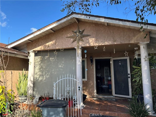 view of exterior entry with stucco siding