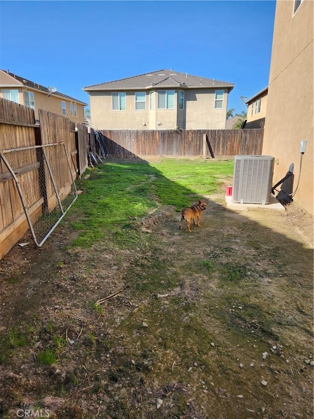 view of yard with cooling unit and a fenced backyard