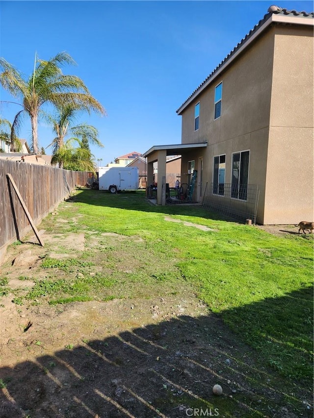 view of yard with a fenced backyard and a patio