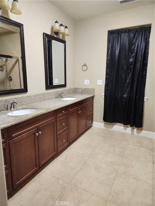 bathroom with curtained shower, visible vents, a sink, and double vanity