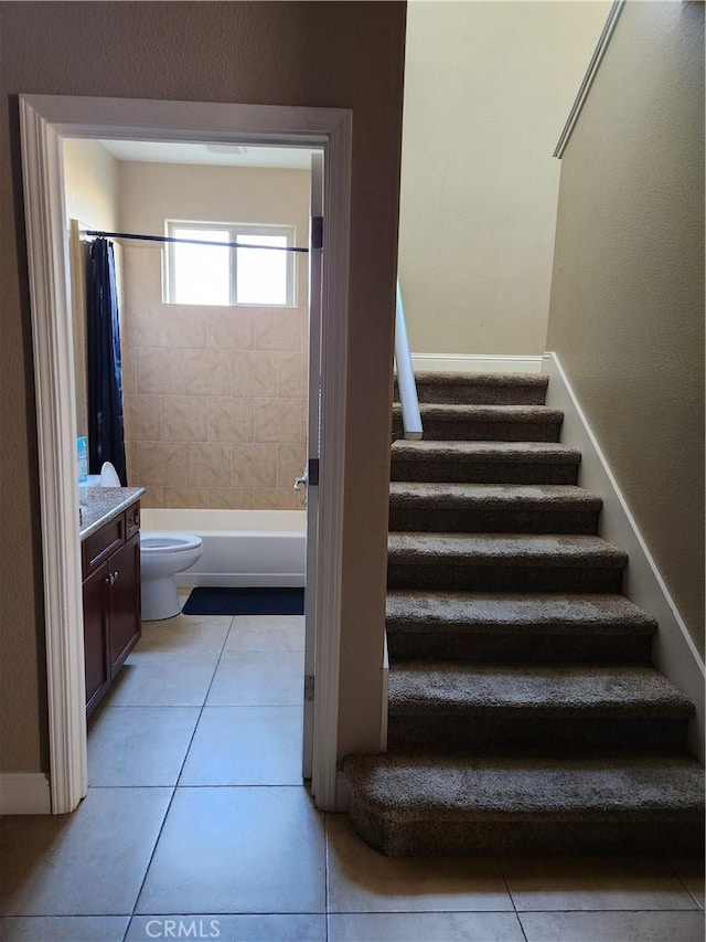 stairs with tile patterned flooring and baseboards