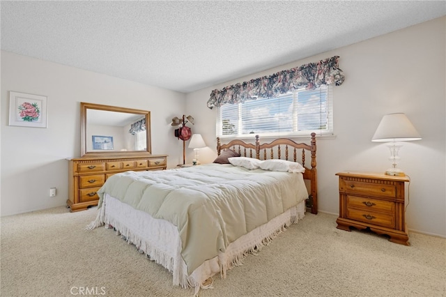 bedroom with carpet floors and a textured ceiling