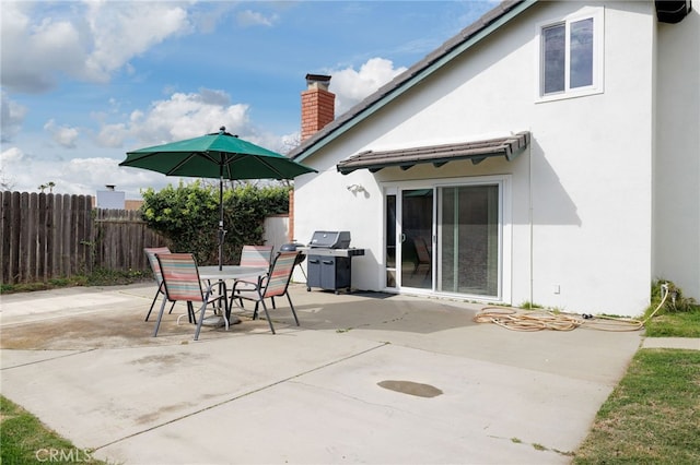 view of patio / terrace with outdoor dining space, fence, and area for grilling