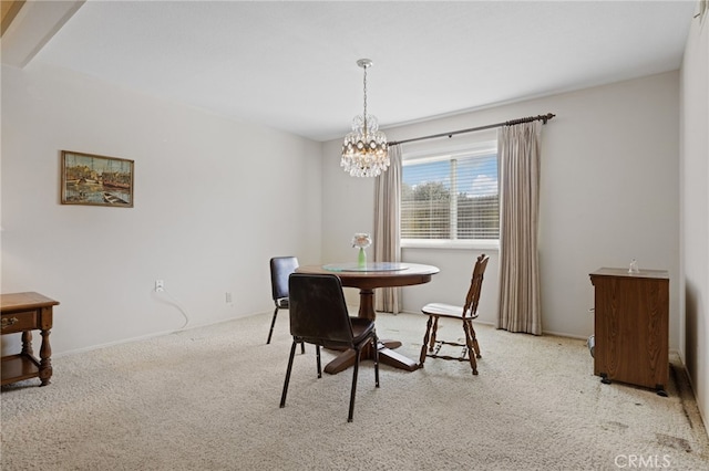 carpeted dining room featuring an inviting chandelier