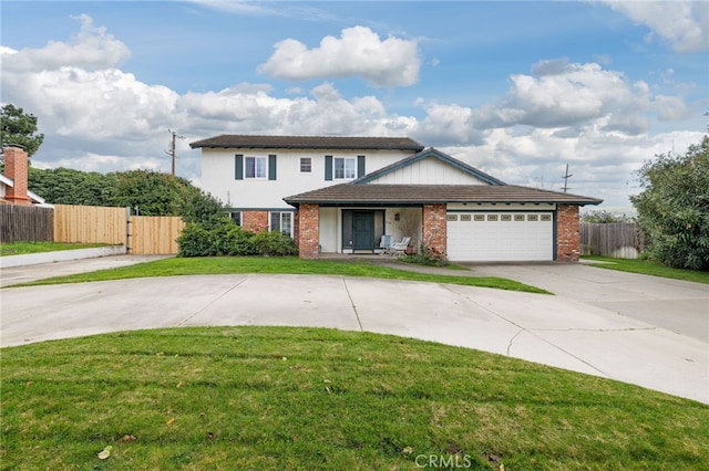 traditional home featuring brick siding, an attached garage, fence, driveway, and a front lawn