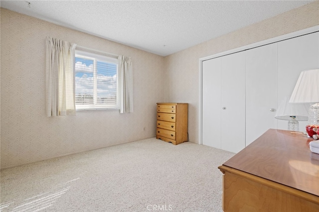 carpeted office space with a textured ceiling