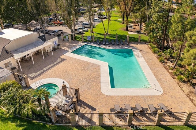 pool featuring a patio area, fence, and a hot tub