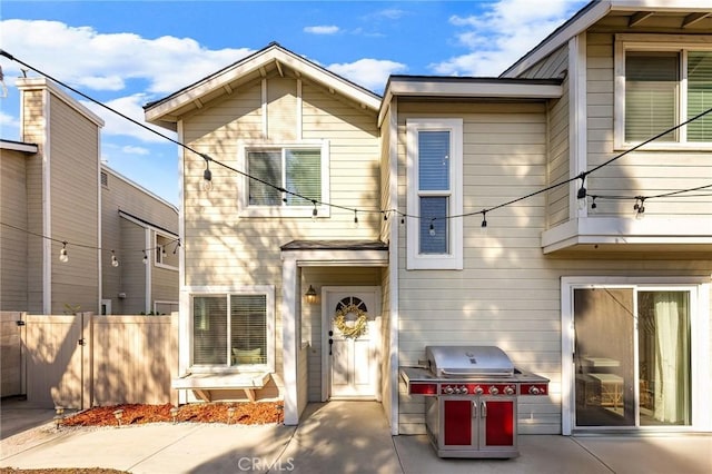 view of front of home featuring fence