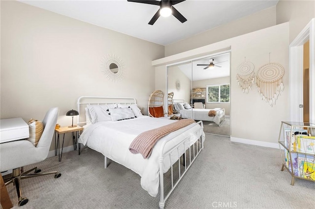 bedroom featuring ceiling fan, a closet, baseboards, and carpet flooring