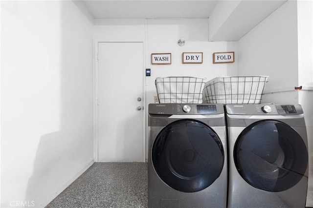 clothes washing area with washer and dryer and laundry area