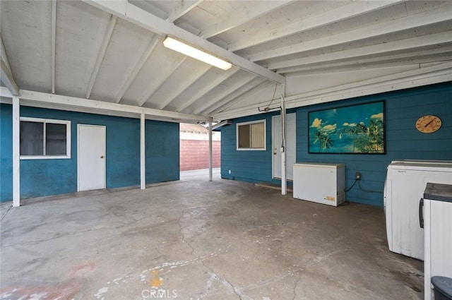 interior space with vaulted ceiling and independent washer and dryer