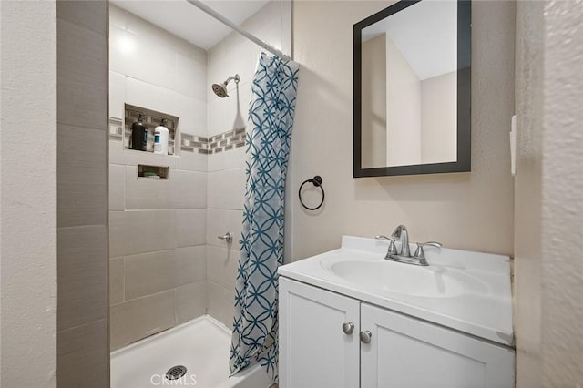 full bathroom featuring a shower stall and vanity