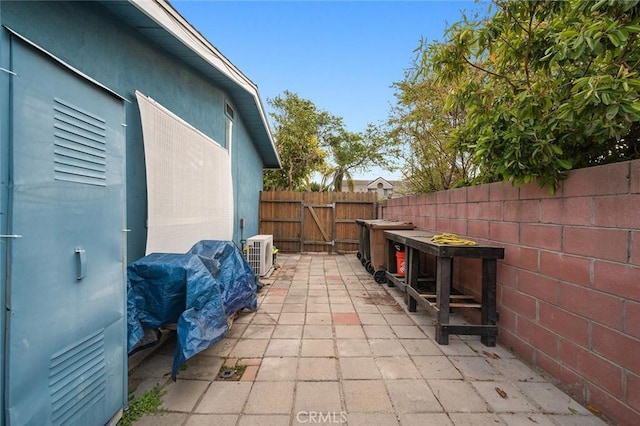 view of patio / terrace with ac unit and a fenced backyard