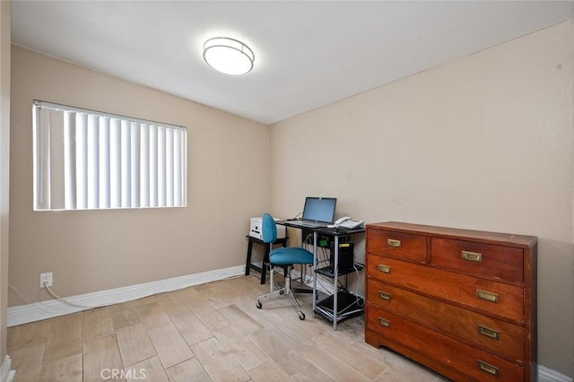 office space with light wood-style flooring and baseboards