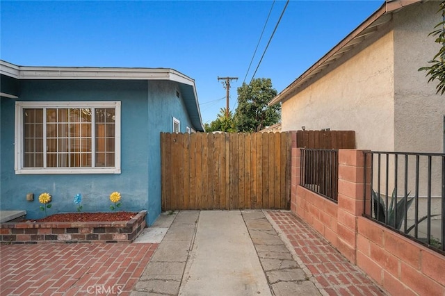 view of property exterior with fence and stucco siding