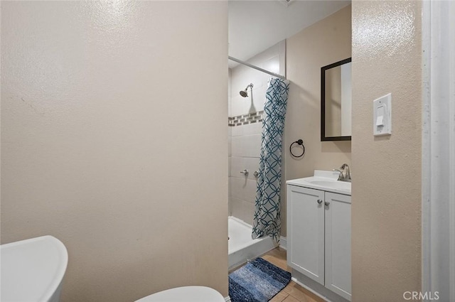 bathroom with toilet, a shower stall, and vanity