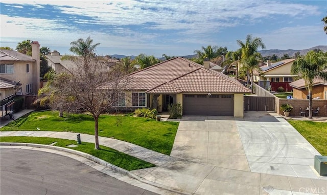 view of front facade featuring a garage, a tile roof, fence, a front yard, and stucco siding