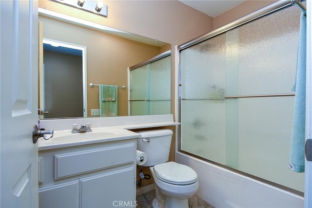 bathroom with enclosed tub / shower combo, vanity, and toilet