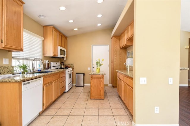 kitchen featuring light tile patterned floors, lofted ceiling, recessed lighting, white appliances, and a sink