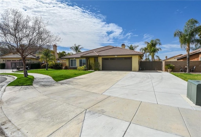 ranch-style house featuring an attached garage, a front yard, fence, driveway, and a tiled roof