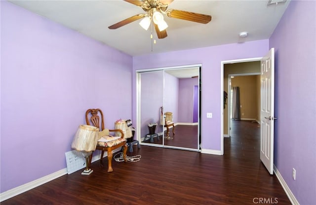 sitting room featuring ceiling fan, baseboards, and wood finished floors