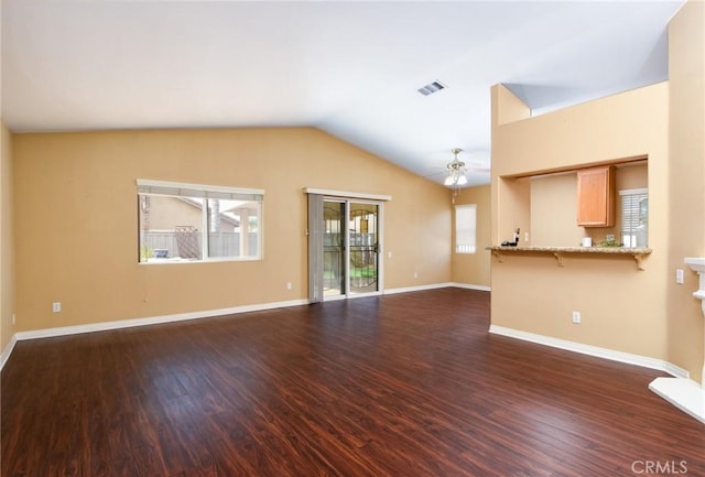 unfurnished living room featuring baseboards, visible vents, dark wood finished floors, a ceiling fan, and lofted ceiling