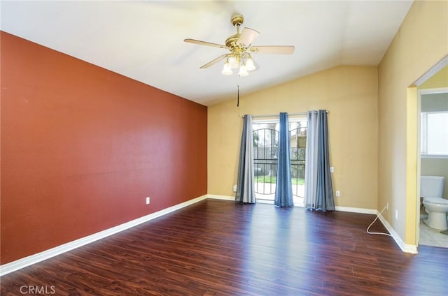 spare room with a ceiling fan, baseboards, vaulted ceiling, and wood finished floors