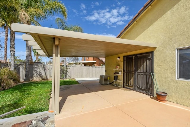 view of patio / terrace featuring a carport, fence, and central AC unit