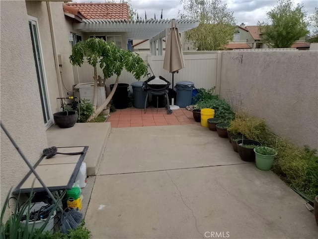 view of patio / terrace featuring a fenced backyard and a pergola