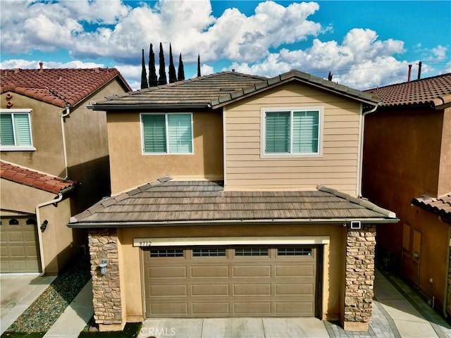 view of front of house featuring stone siding, a tile roof, and stucco siding