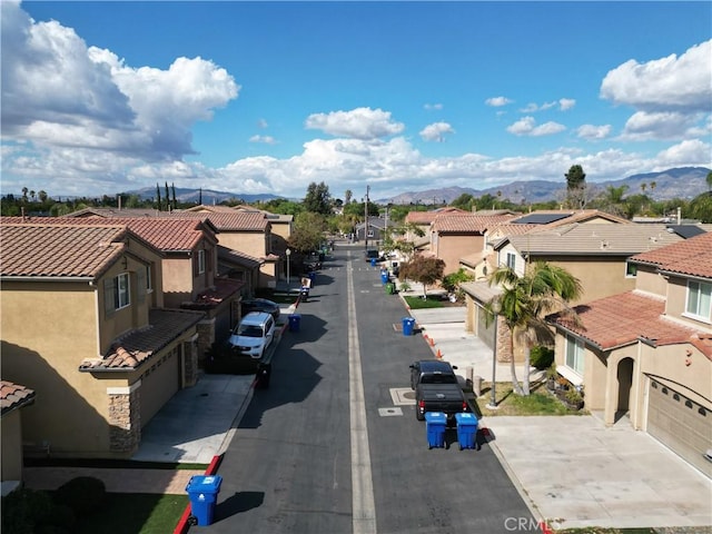 view of street with a residential view and a mountain view