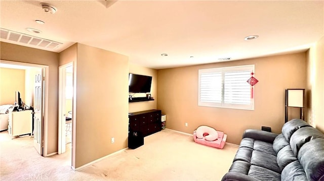 carpeted living area featuring baseboards and visible vents