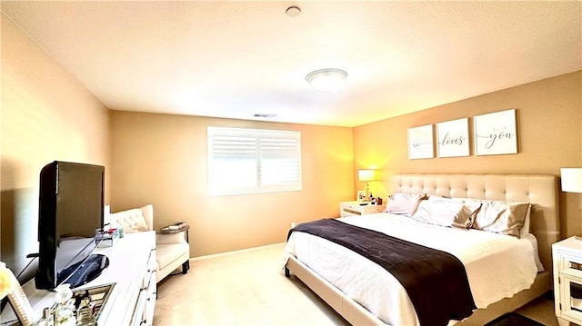 carpeted bedroom featuring visible vents