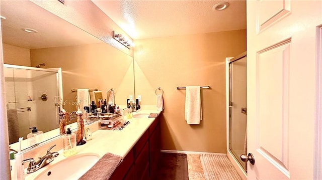 full bath featuring a stall shower, a sink, and tile patterned floors