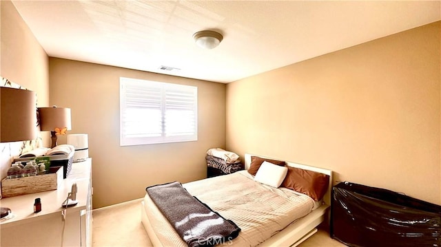 carpeted bedroom featuring visible vents and baseboards