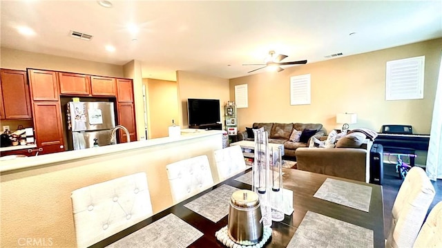 dining room with a ceiling fan and visible vents