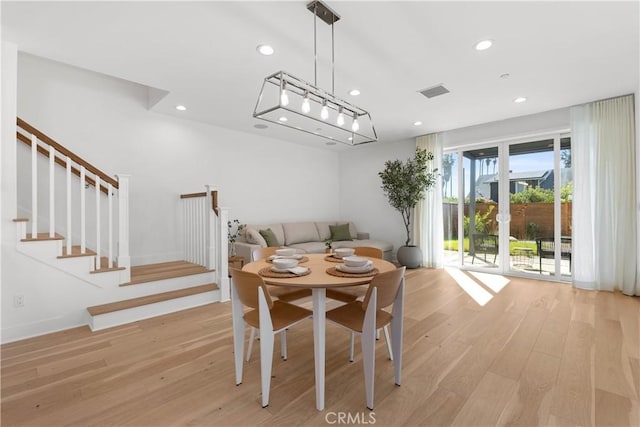 dining room with stairway, recessed lighting, visible vents, and light wood-style floors