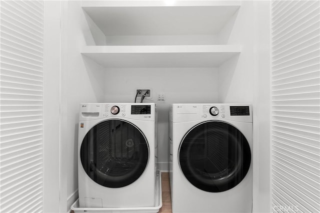 washroom featuring laundry area and separate washer and dryer