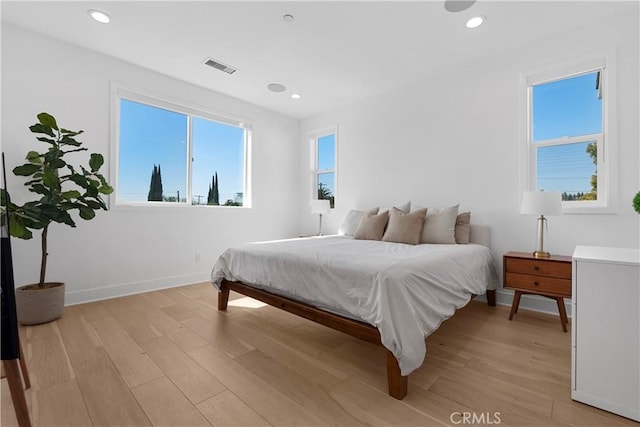 bedroom featuring recessed lighting, visible vents, baseboards, and light wood finished floors