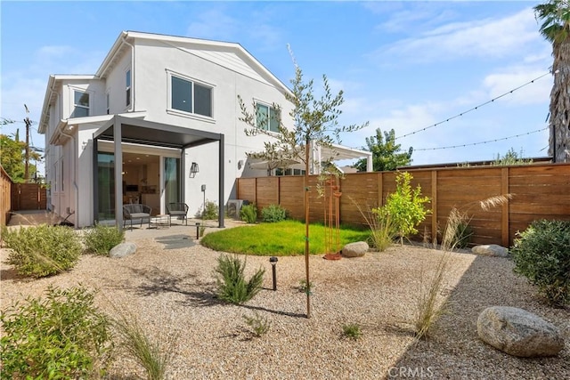 back of property with a patio, a fenced backyard, and stucco siding