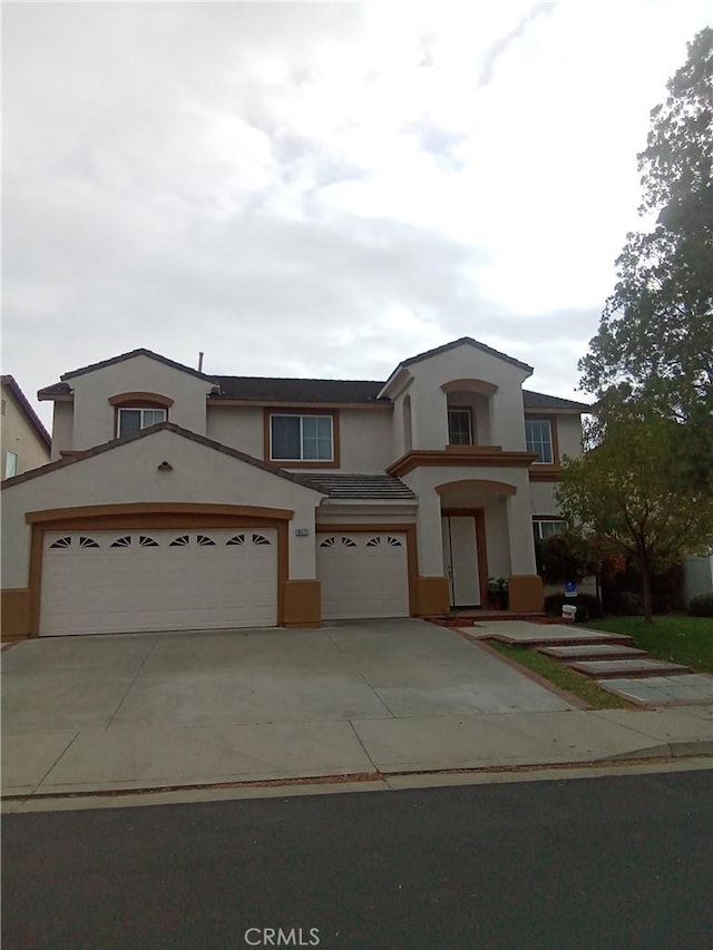 view of front of home with concrete driveway and stucco siding