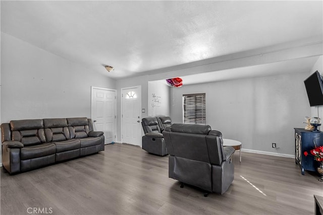 living area with wood finished floors and baseboards